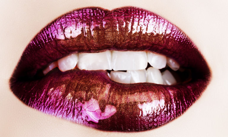 macro of beautiful lips with purple and gold lipstick